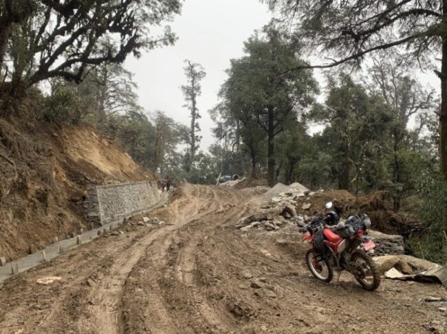 An adventure motorcycle navigating rugged trails on the epic Mighty Everest to Annapurna ride expedition in Nepal.