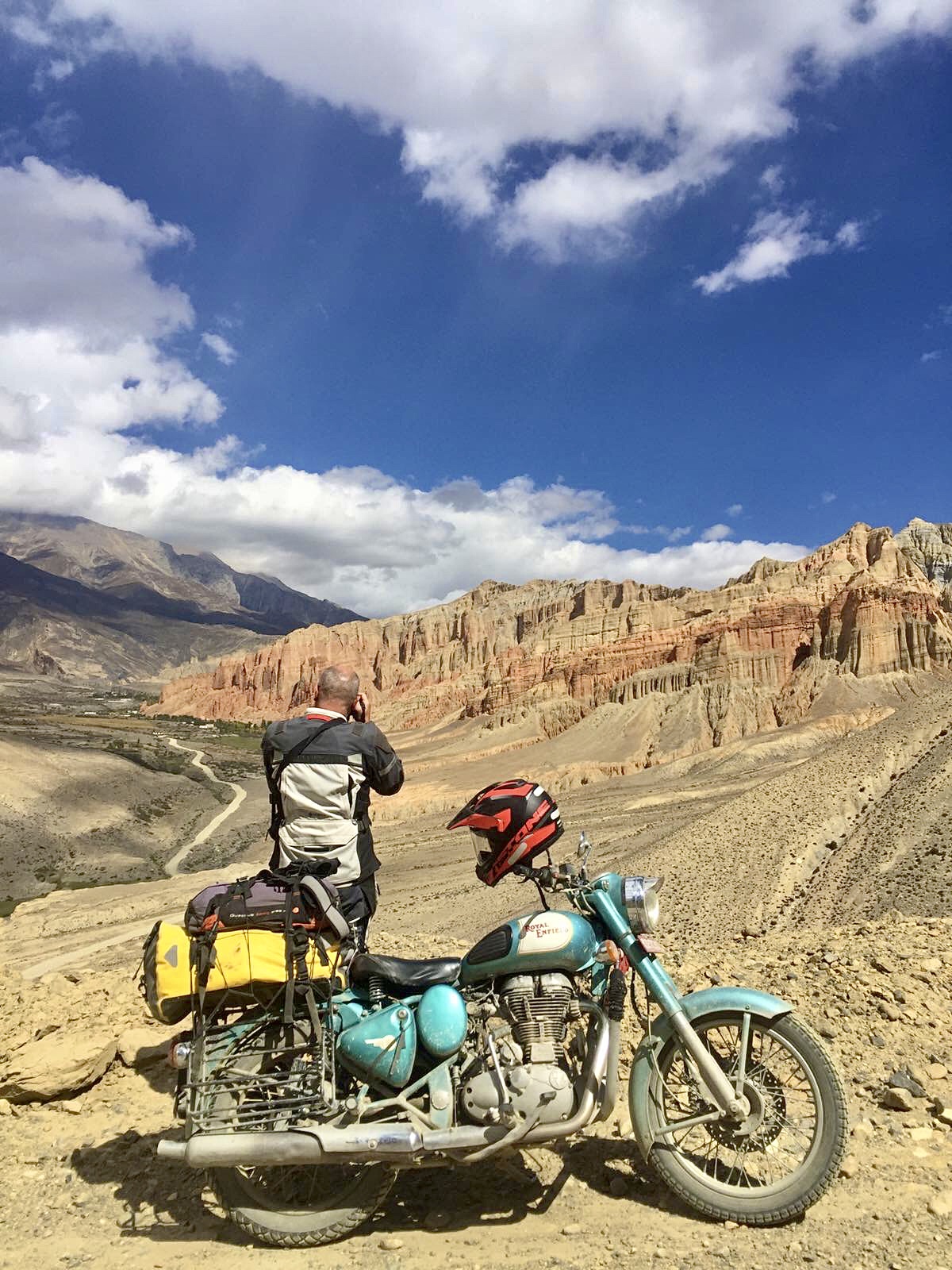 Barren desert landscape of Upper Mustang with winding trails during a motorcycle ride and trek.