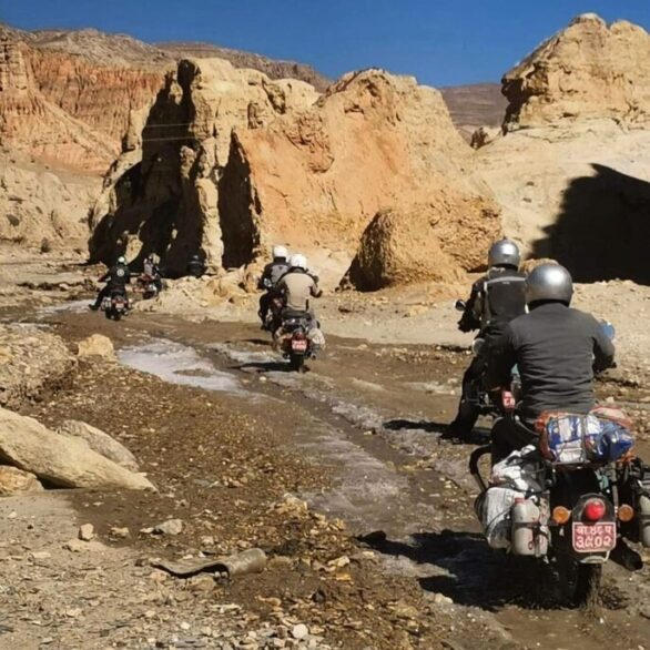 The rugged desert landscape of Upper Mustang, with barren mountains, winding dirt roads, and dramatic skies in Nepal. Through the Wild Landscapes of Upper Mustang