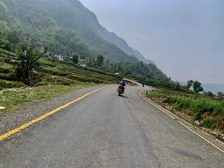 Motorcycles touring the winding Prithvi Highway river valley route from Kathmandu to Besisahar on a Bikemandu tour