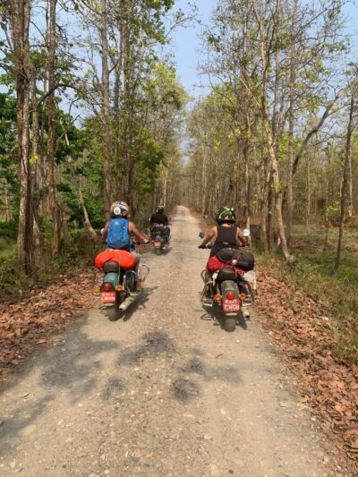 Adventure riders exploring the Terai forest route on the Everest gateway to Chitwan park motorcycle tour.