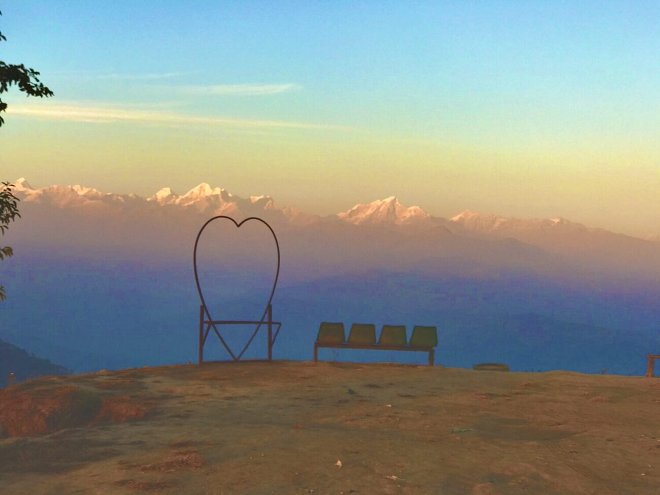 Panoramic sunrise view of the distant Himalayan peaks over Nagarkot hills on a 5 days Everest gateway to chitwan park motorcycle tour.